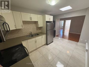 Oakville (Oo Old Oakville) apartment for rent - A kitchen with white cabinets and a refrigerator.