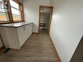 Whitchurch-Stouffville apartment for rent - A room with a window, a bench, and a mirror.