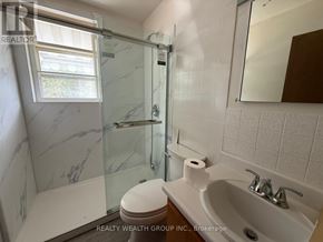 Whitchurch-Stouffville apartment for rent - A white toilet sits next to a sink in a bathroom.