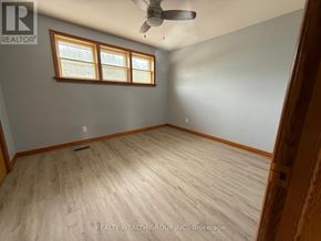 Whitchurch-Stouffville apartment for rent - A room with a ceiling fan and a window.