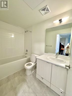 Toronto (Beechborough-Greenbrook) condo for rent - A white bathroom with a toilet, sink, and mirror.