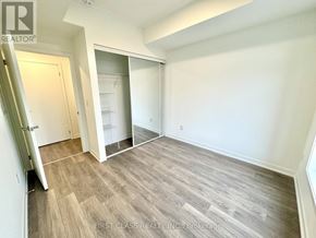 Toronto (Beechborough-Greenbrook) condo for rent - A room with a wooden floor and white walls.