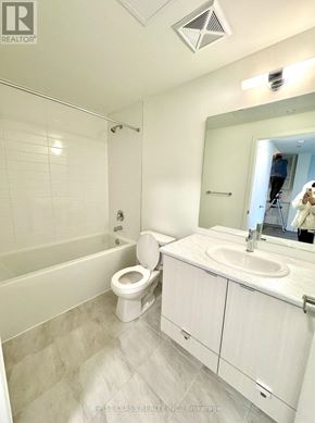 Toronto (Beechborough-Greenbrook) condo for rent - A bathroom with a toilet, sink, and mirror.
