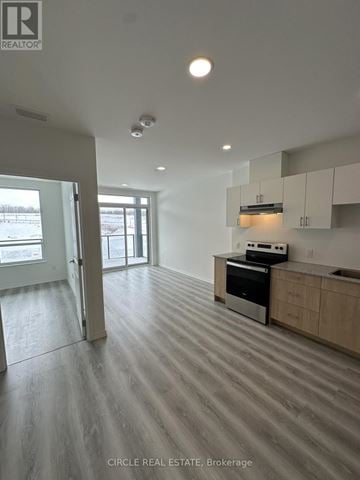 Guelph (Willow West/Sugarbush/West Acres) condo for rent - A kitchen with a stove top oven and a microwave.
