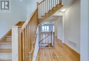 Kitchener apartment for rent - A wooden staircase with a white wall on the side.