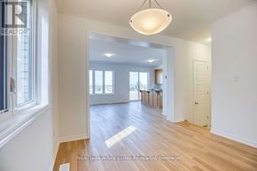 Kitchener apartment for rent - A well-lit, spacious room with wooden floors and white walls.