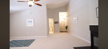 Owings Mills apartment for rent - A living room with a ceiling fan and a rug on the floor.
