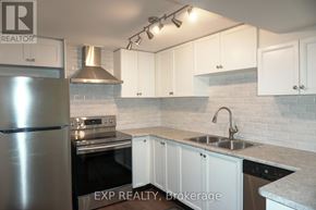 Newmarket (Glenway Estates) apartment for rent - A kitchen with white cabinets and a stainless steel refrigerator.