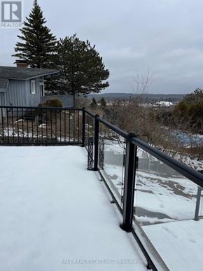 Asphodel-Norwood apartment for rent - A snow-covered ground with a metal railing.
