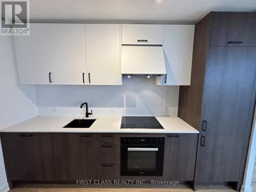 Toronto (Banbury-Don Mills) condo for rent - A kitchen with a white countertop and dark wood cabinets.