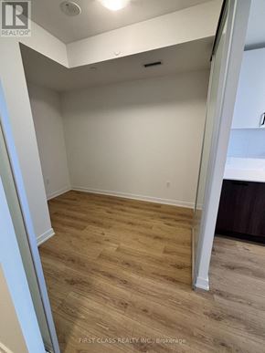 Toronto (Banbury-Don Mills) condo for rent - A room with wooden flooring and white walls.