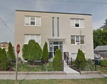 Oshawa apartment for rent - A two-story building with a stop sign in front.
