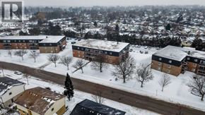 London apartment for rent - A snowy residential area with houses and trees.