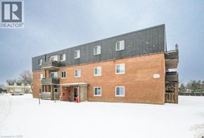 London apartment for rent - A large red brick building with a black roof and a sign that says REALTOR.