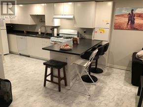 Ottawa apartment for rent - A kitchen with a table and chairs in front of it.