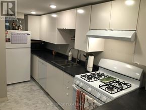 Ottawa apartment for rent - A white stove with a green burner is in a kitchen with white cabinets.
