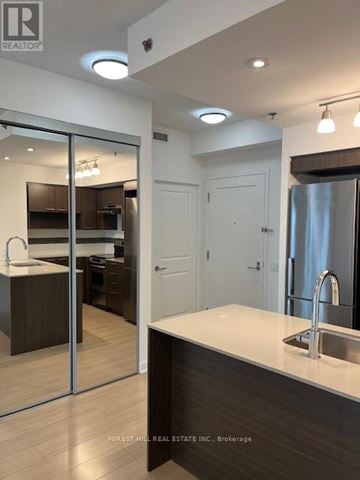 Toronto (Forest Hill South) house for rent - A modern kitchen with a sink and a refrigerator.