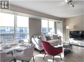 Toronto (Church-Yonge Corridor) condo for rent - A living room with a red chair and a white couch.