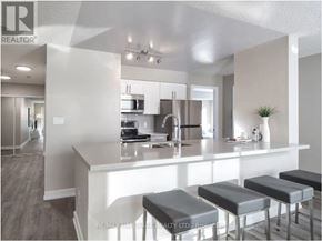 Toronto (Church-Yonge Corridor) condo for rent - A modern kitchen with a bar stool in front of the island.