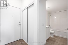 Clarington (Bowmanville) condo for rent - A white bathroom with a toilet, sink, and bathtub.