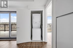 Clarington (Bowmanville) condo for rent - A white refrigerator is in the middle of a room with a door open.