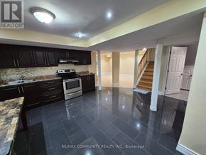 Ajax (Northwest Ajax) apartment for rent - A kitchen with black cabinets and a stone countertop.
