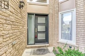 Oakville (Jc Joshua Creek) townhouse for rent - A brick wall with a glass door and a window.