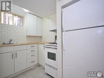 Brampton (Downtown Brampton) apartment for rent - A white kitchen with a refrigerator on the right.