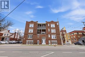 Hamilton (St. Clair) multi-family for rent - A building with the sign "Royal LePage Platinum Realty Brokerage" in front of it.