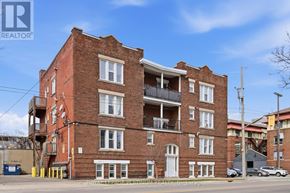 Hamilton (St. Clair) multi-family for rent - A red brick building with a balcony on the second floor.