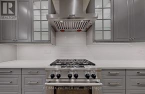 Vaughan (Patterson) apartment for rent - A modern kitchen with a stove top oven and cabinets.
