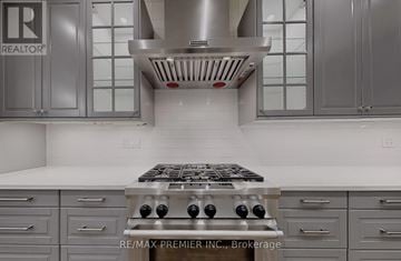Vaughan (Patterson) apartment for rent - A modern kitchen with a stove top oven and cabinets.