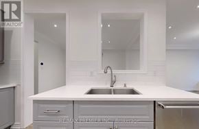 Vaughan (Patterson) apartment for rent - A white kitchen with a sink and a brokerage logo.