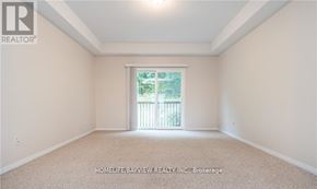 Barrie (Edgehill Drive) apartment for rent - A room with a window and a carpeted floor.