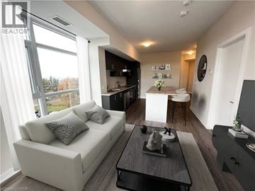 Stoney Creek condo for rent - A living room with a white couch and a coffee table.