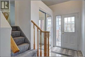 Cobourg townhouse for rent - A hallway with a staircase leading to the second floor.