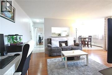 Hamilton condo for rent - A living room with a grey couch and a white coffee table.