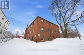 Toronto (O'connor-Parkview) multi-family for rent - A red brick building with the number 995 on it is surrounded by snow.