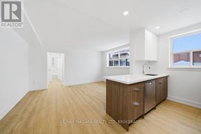 Toronto (O'connor-Parkview) multi-family for rent - A spacious kitchen with wooden floors and white countertops.
