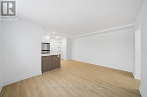 Toronto (O'connor-Parkview) multi-family for rent - A spacious room with wooden flooring and white walls.