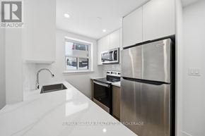 Toronto (O'connor-Parkview) multi-family for rent - A modern kitchen with stainless steel appliances and white cabinetry.