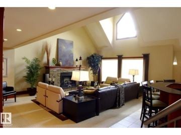 Edmonton apartment for rent - A living room with a fireplace and a painting on the wall.