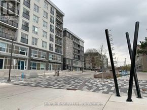 Waterloo condo for rent - A view of a street with apartment buildings and a playground.