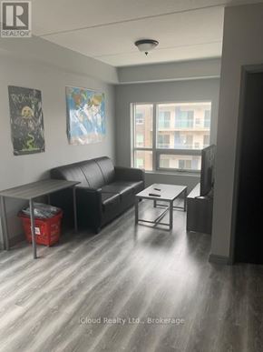 Waterloo condo for rent - A living room with a couch, coffee table, and pictures on the wall.