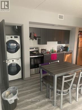 Waterloo condo for rent - A modern kitchen with a table and chairs.