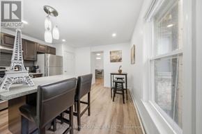Hamilton (Corktown) triplex for rent - A modern kitchen with a dining area and a large window.