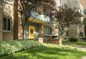 Denver apartment for rent - the front of a brick apartment building with a yellow door