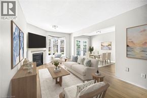 Stoney Creek townhouse for rent - A living room with a fireplace and a painting on the wall.
