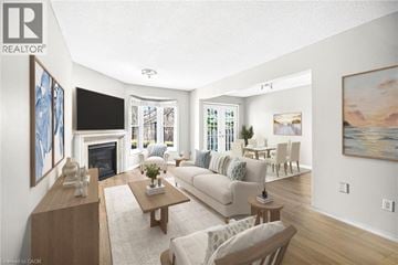 Stoney Creek townhouse for rent - A living room with a fireplace and a painting on the wall.