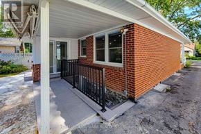 St. Catharines (Port Dalhousie) apartment for rent - A small red brick house with a porch.